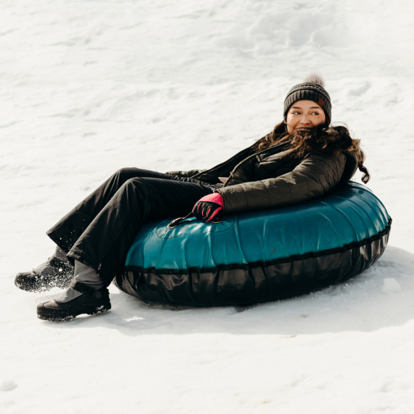 Girl snow tubing at Leland Snowplay